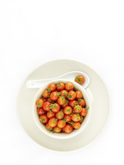 Top view of fresh cherry tomatoes in bowl isolated on white background