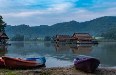 The wooden raft and Kayak in the water reservoirs and mountain views.