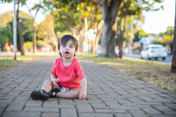 Cute baby boy toddler - on the sidewalk