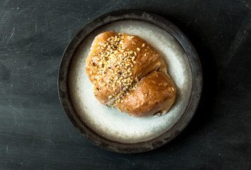 single pie with apples and nuts  on a dark, rustic table, top view