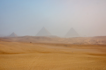 Fototapeta na wymiar Foggy morning at the Pyramids complex in Egypt