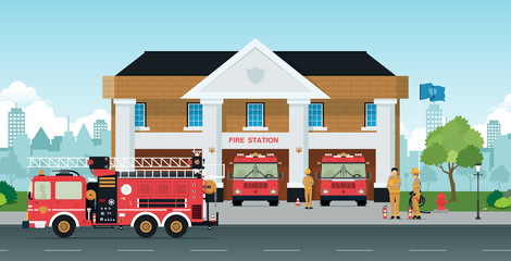 Obraz premium Staff and fire trucks are in front of the station.
