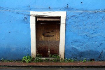 Translation: the blue vintage and colorful windows and doors in Goa City.