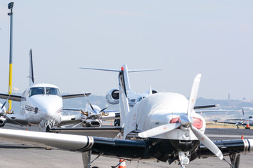 Luxury private jets lined up on the runway