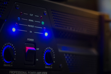 Hand turning the volume knob of an amplifier up to the maximum, Concept image for noisy environment.