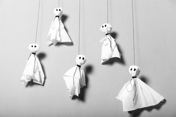 Scary halloween background, black and white paper ghosts.