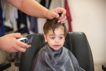 Cute baby boy toddler - cutting hair.