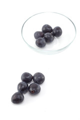 Fresh black grapes on white
