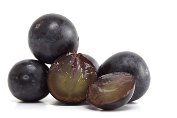 Fresh black grapes on white