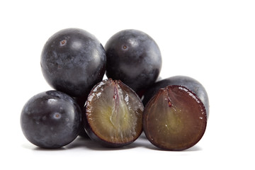 Fresh black grapes on white