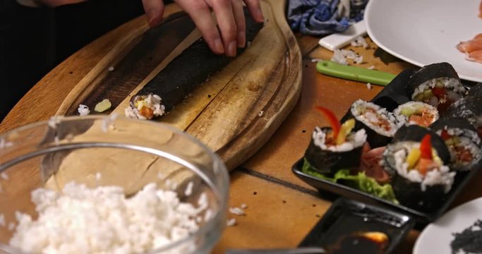 Cut sushi roll on wooden board