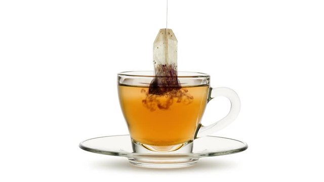 Animated looping image, tea bag in infusion into glass cup of tea on white bachground.