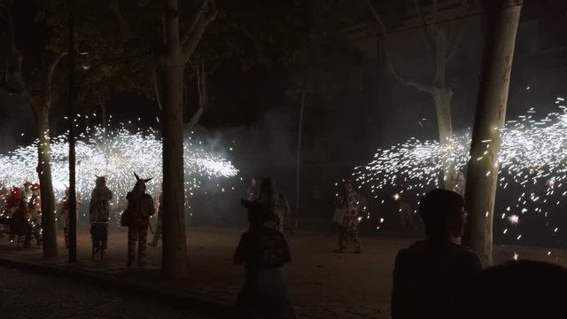 Traditional correfoc performance. In the correfoc, a group of individuals will dress as devils or Diables and light fireworks - fixed on devil's pitchforks