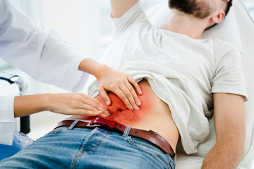Patient with severe abdominal pain. Doctor is checking body that caused something like bladder...