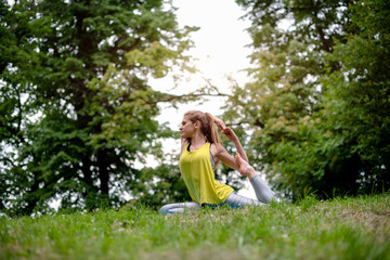 Young fit woman doing yoga exercises