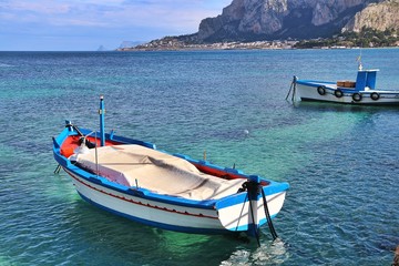 Fototapeta na wymiar Palermo, Sicily, Italy. Colorful fishing boat in the sea in front of Mondello.