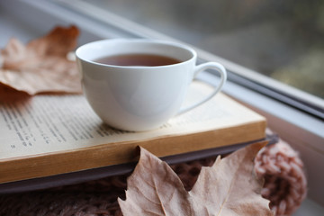 Hot drink and open book