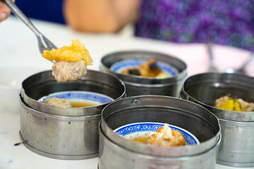 Dim sum on a food shelves, various Chinese steamed dumpling in bamboo basket steamer in Chinese restaurants.Yumcha or Dimsum