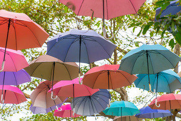 The sky of colorful umbrellas background.Street decoration.Colorful Hanging Umbrellas