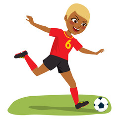 Young beautiful black soccer player girl playing football with black and red uniform