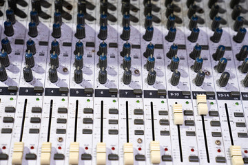 Slide the volume control of the mixer.sound studio adjusting record equipment console sound engineer