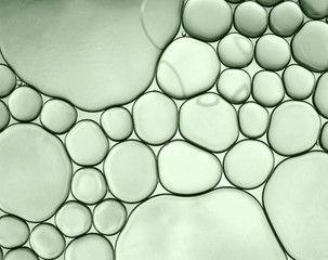 Abstract macro shot of oil drops on water