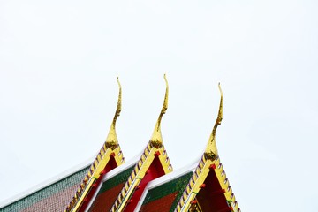 art on roof church at buddhist temple in thailand.