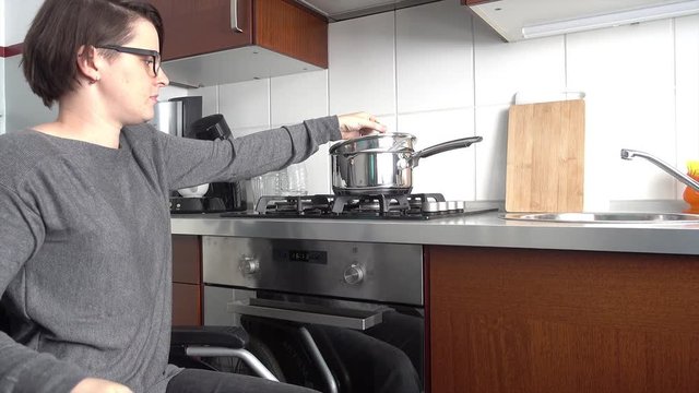 Disabled woman in the kitchen cooking