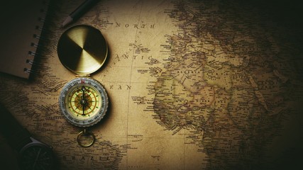 Old compass on antique map. - vintage style