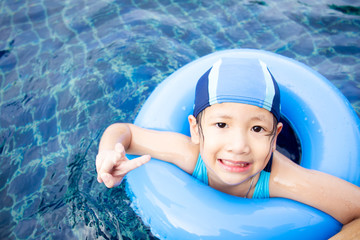 Little girl age between 5-10 years old enjoying swimming close up.