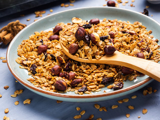 Homemade granola with honey, raisins, cherries, sesame and chestnuts on blue