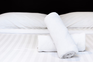 Set of towel on the bed in the room in hotel close up.