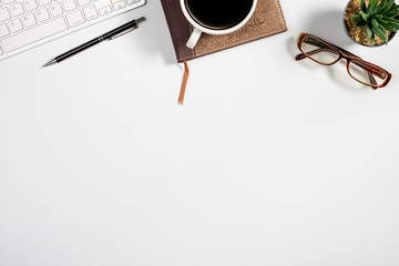 Workspace with computer, colour pencils and coffee mug on white background. Flat lay, top view