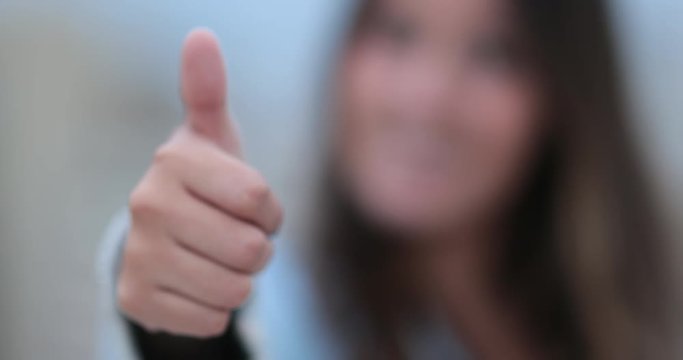 Girl giving positive thumb up to camera3