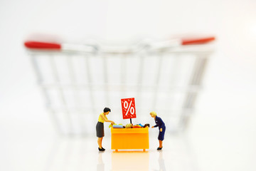 Miniatrue people: Shoppers buy goods on sale with discount tray and shopping cart. Tourism,...