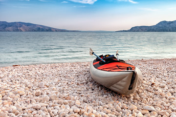 Empty kayak on beach over sea bay landscape, background with copyspace