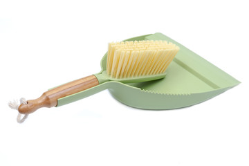 Green dustpan and natural bamboo broom set isolated on white background