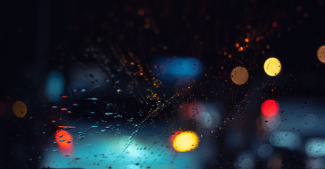 Rain drops on glass abstract rainning and traffic jam on road in rainy season