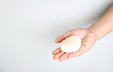 soap in a hand on a light background