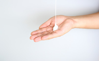cream in hand on a light background