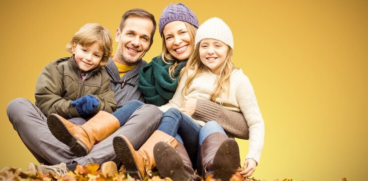 Composite image of portrait of happy family sitting on field at
