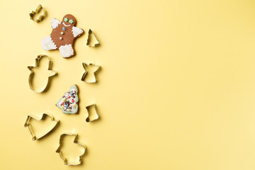 Christmas cookies various shape cutter on yellow background with copy space. Top view. Flat lay....