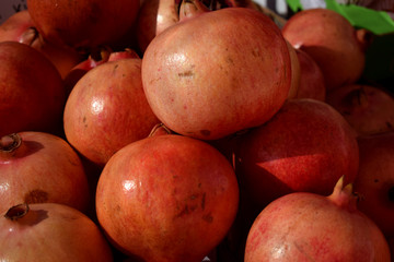 Fresh ripe burgundy pomegranates on the counter market