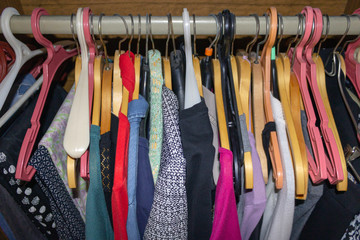 Clothes hanging on hangers in the closet