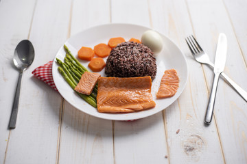 Health food concept, salmon with rice and vegetable on wood background