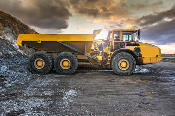 Heavy stone cargo truck in the construction works of a road