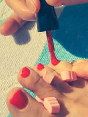 Woman pedicure with red nail polish