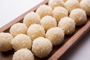Coconut Sweet Laddoo OR Nariyal Ladduis a Popular Festival food from India. Served over moody background, selective focus