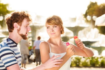 young couple eating ice cream outdoor