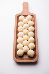 Coconut Sweet Laddoo OR Nariyal Ladduis a Popular Festival food from India. Served over moody background, selective focus